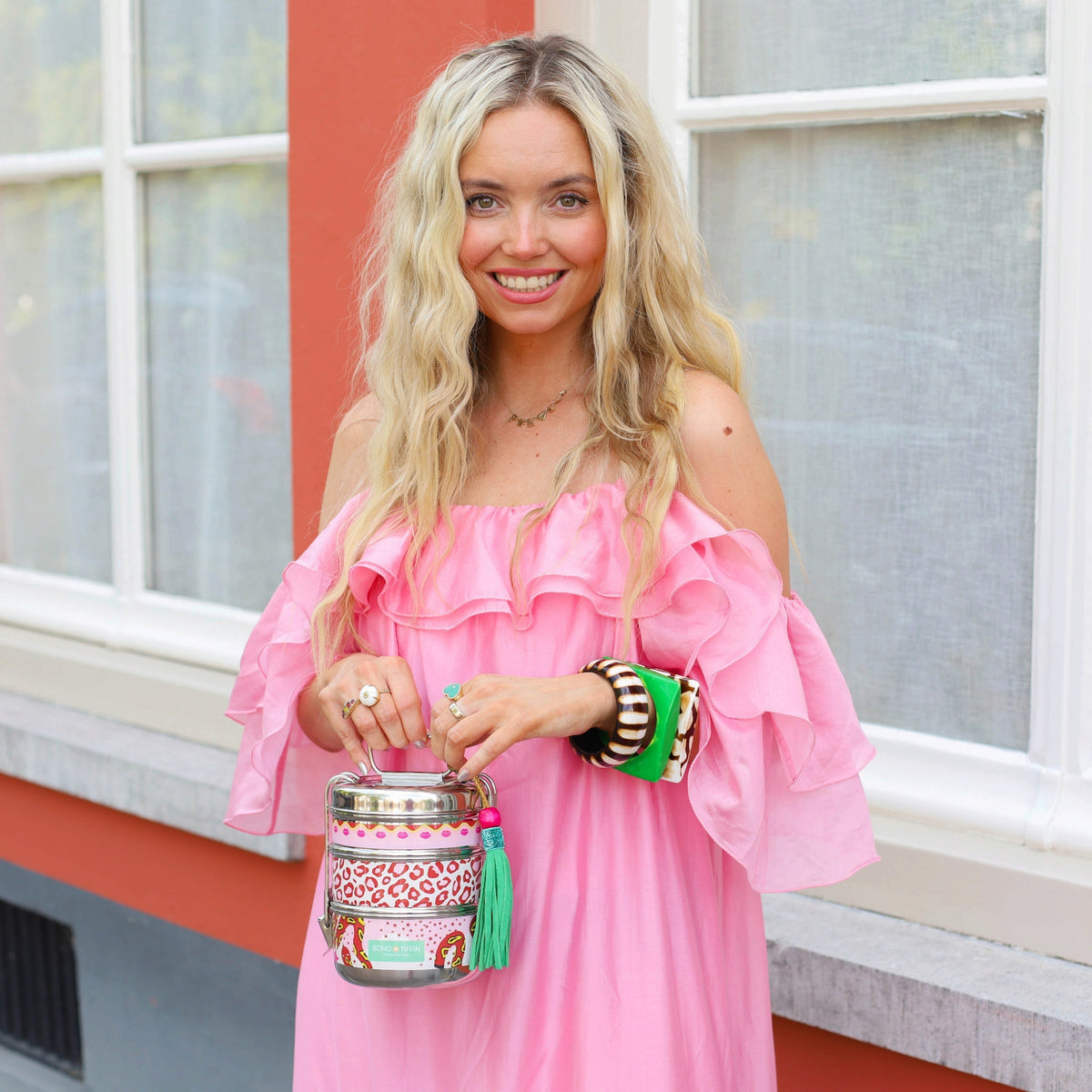 Boho-Tiffin Kiss and Snake stainless steel 3-tier lunchbox with leopard, lip, and snake print held by a smiling woman