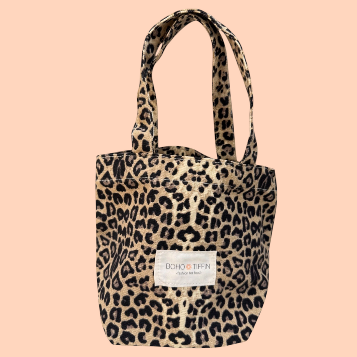 Boho-Tiffin leopard print canvas tote bag with two handles and a branded fabric label on the front.